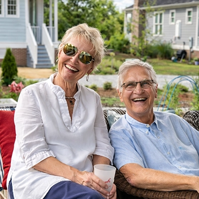 Elizabeth Darby With Husband Sitting On Their Porch